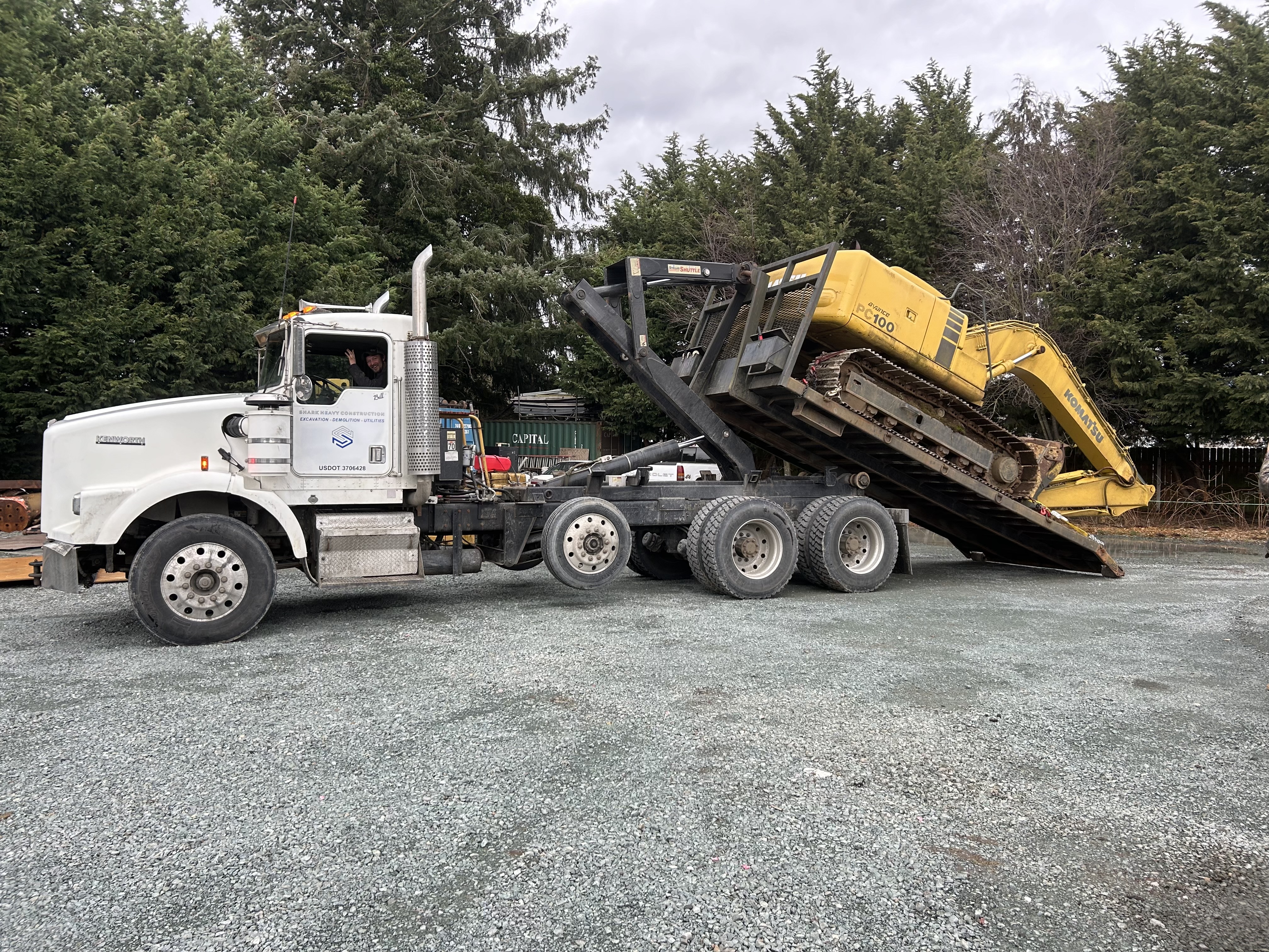 Bill loading a Komatsu excavator onto the Shark Heavy Construction trailer